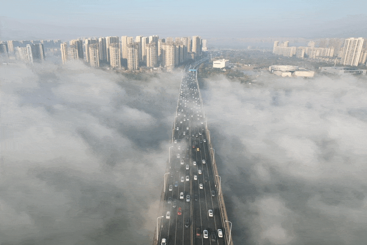 Photos: River of fog engulfs bridge in China