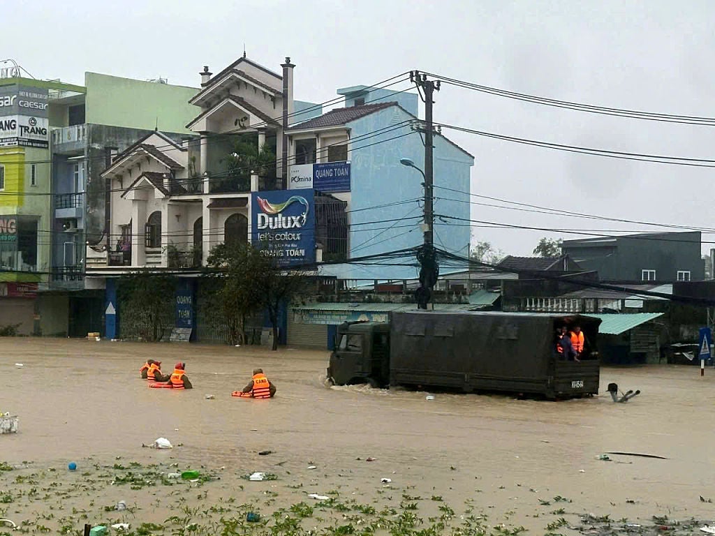 See It: Police rescue baby from deadly flooding that killed at least 41 in Central Vietnam