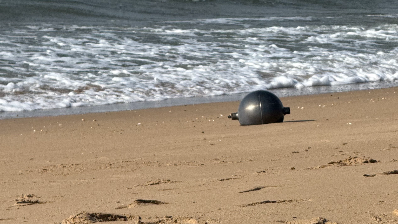 Photos: Mysterious metallic spheres washing up on Australian beach identified
