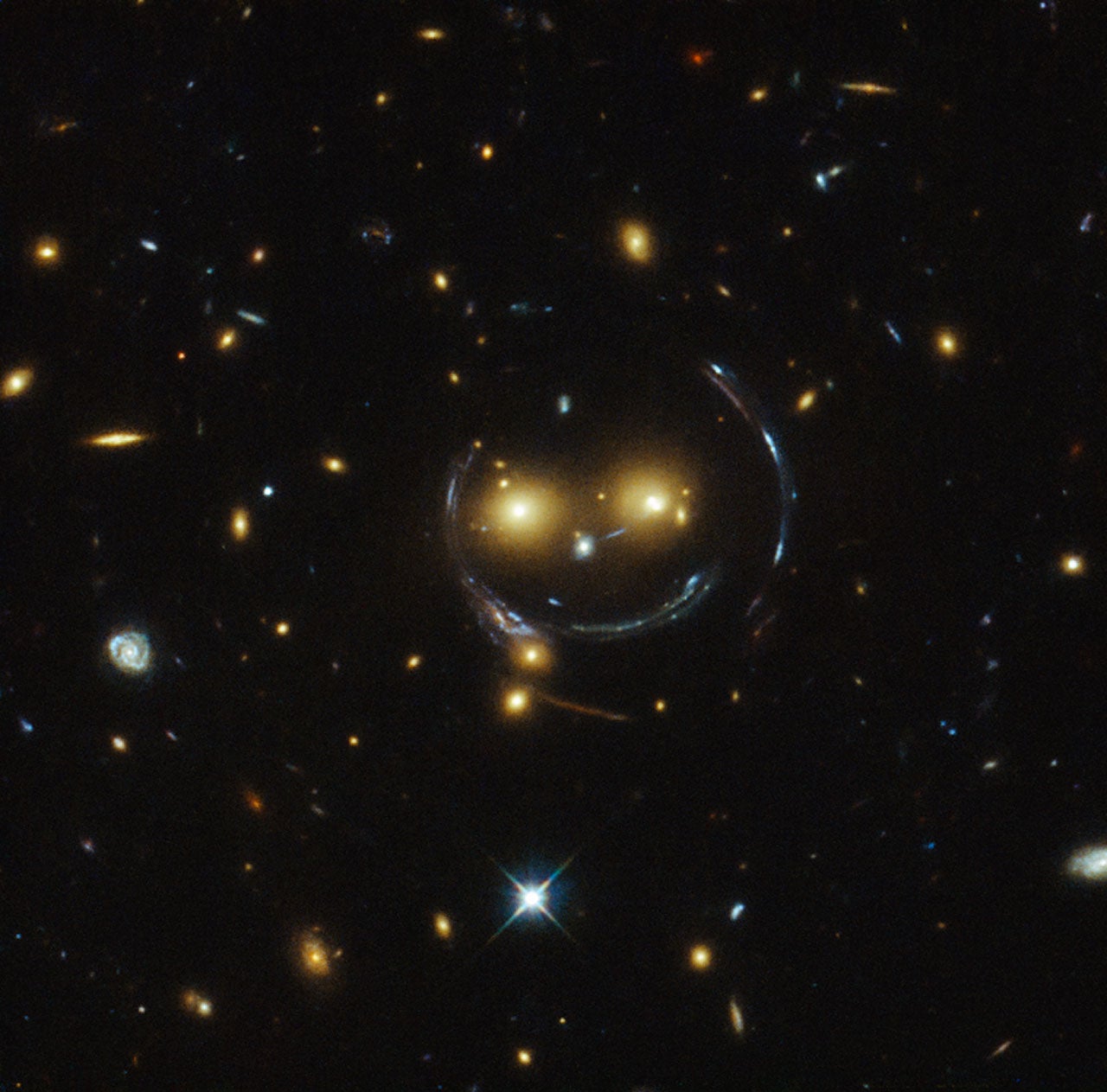 A giant smiley face in space? Hubble captures remarkable galaxy cluster